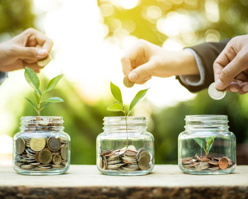 Businessman,Hands,Putting,Money,(coin),Into,The,Glass,Jar,-